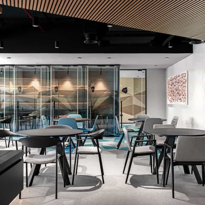 Cozy, contemporary coworking workspace in UAE with modern tables, chairs, and vibrant decor.
