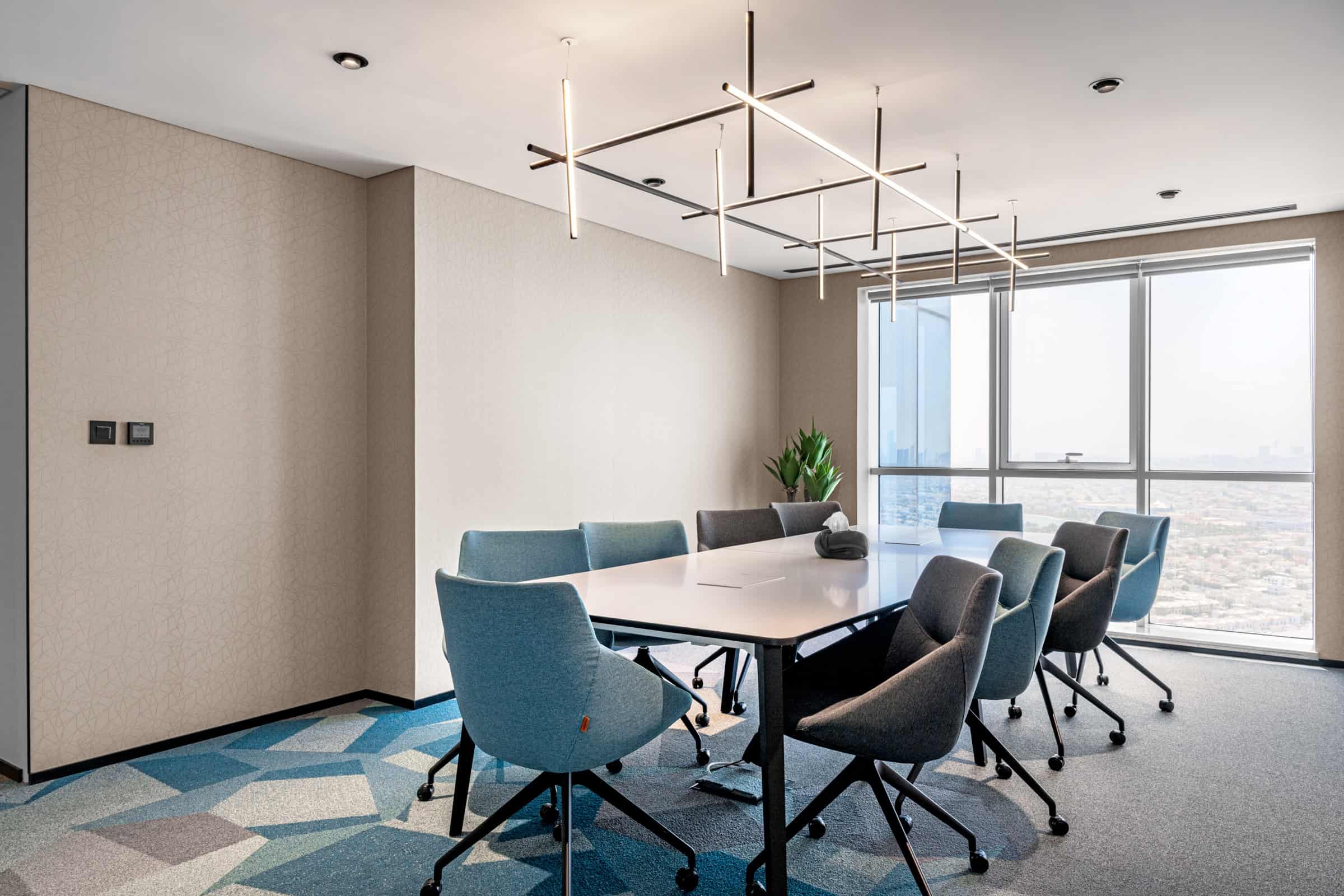 Luxurious office conference room with ergonomic chairs, bright natural light, and stylish decor in Dubai.