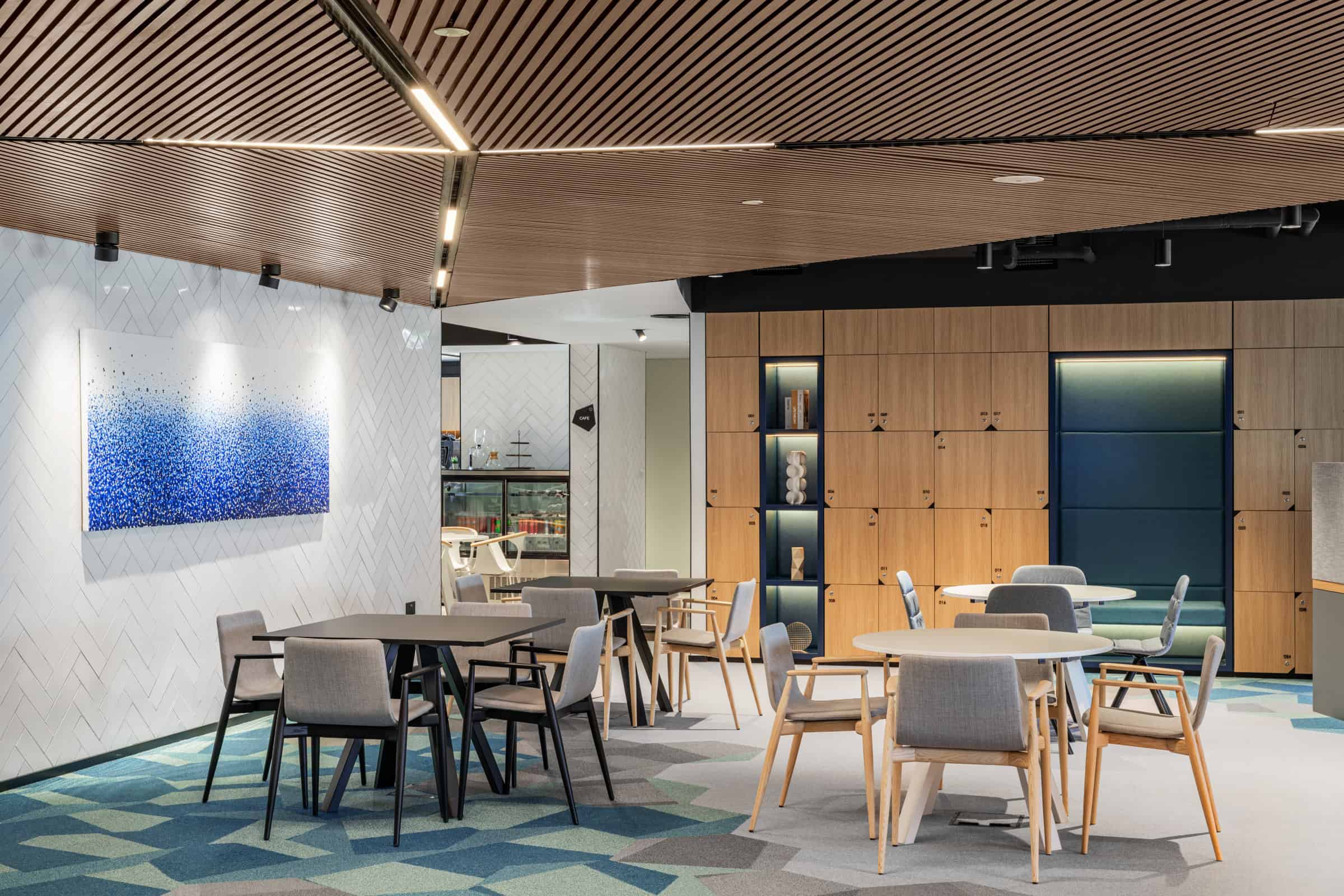 Bright coworking lounge featuring comfortable tables and chairs at Nextspace UAE.