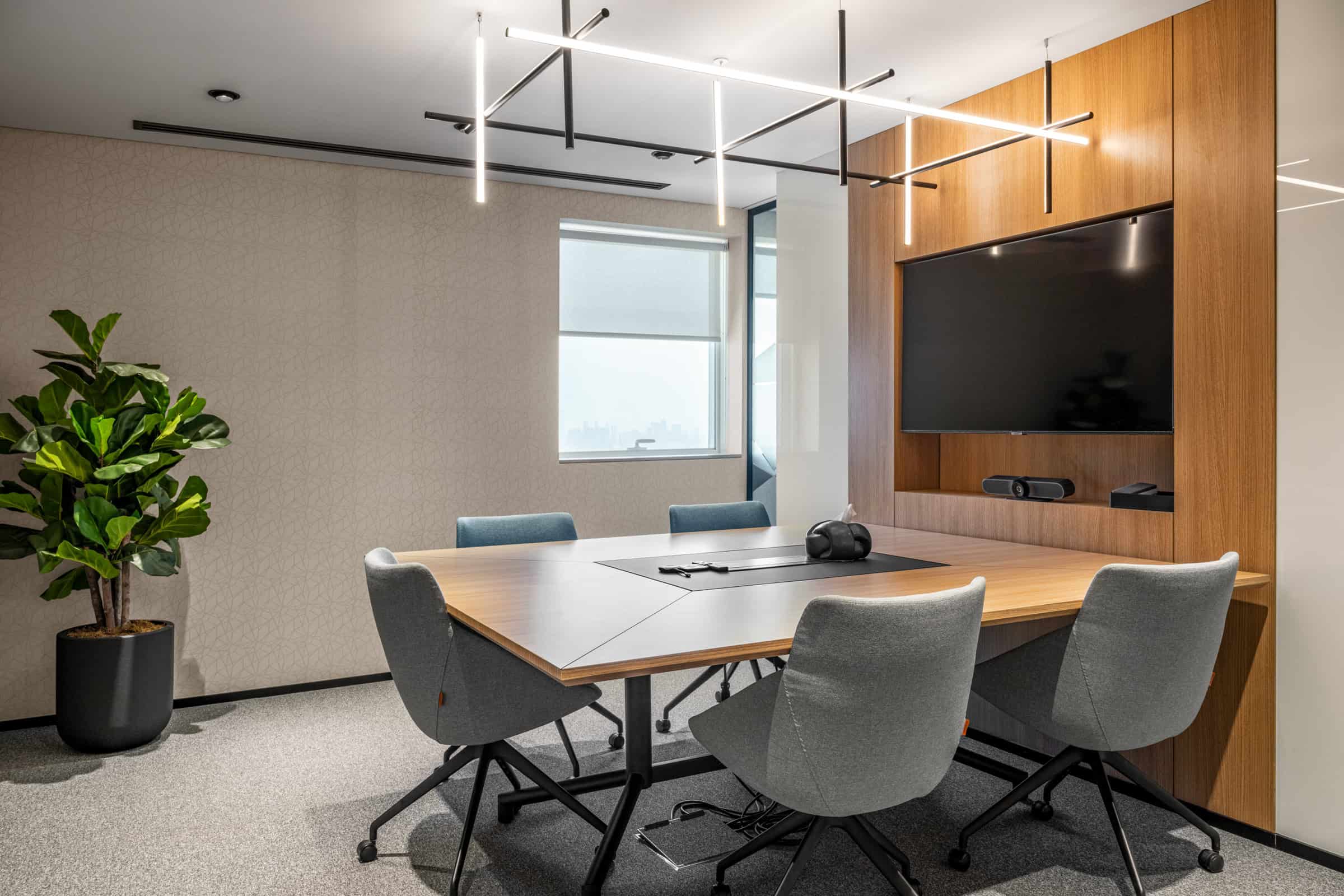 Bright Dubai coworking space with boardroom, conference table, and modern amenities for remote work.