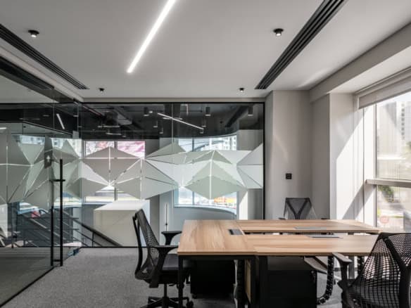 Creative coworking area at Nextspace UAE with contemporary furniture, bright lighting, and panoramic city views.