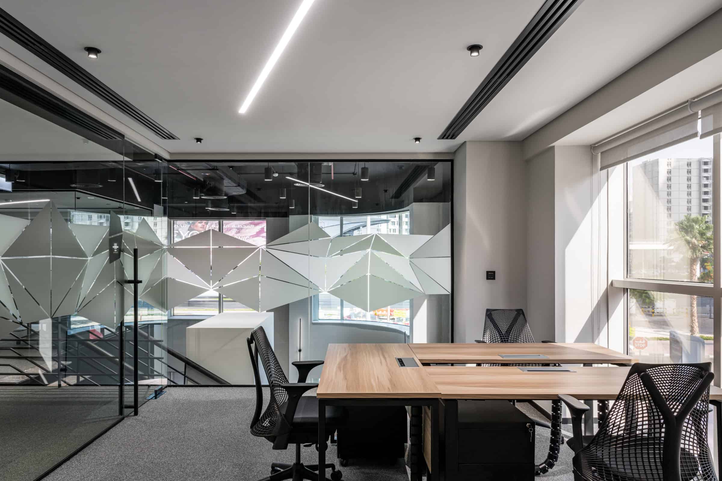 Creative coworking area at Nextspace UAE with contemporary furniture, bright lighting, and panoramic city views.