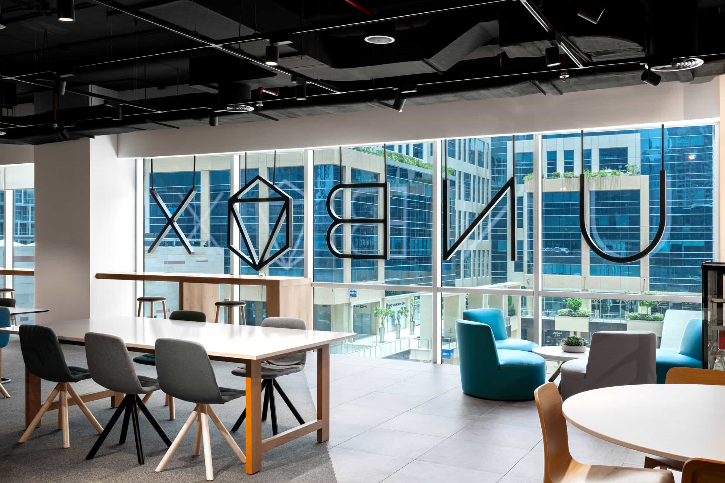 Bright workspace at Nextspace UAE featuring contemporary furniture and city views.