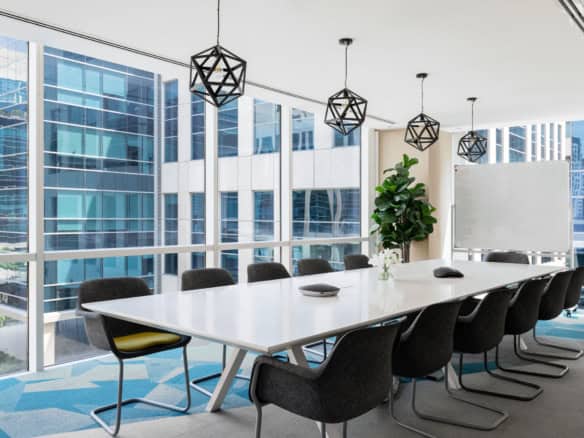 Bright, contemporary conference room with large windows overlooking Dubai's skyline, ideal for meetings and collaborations.