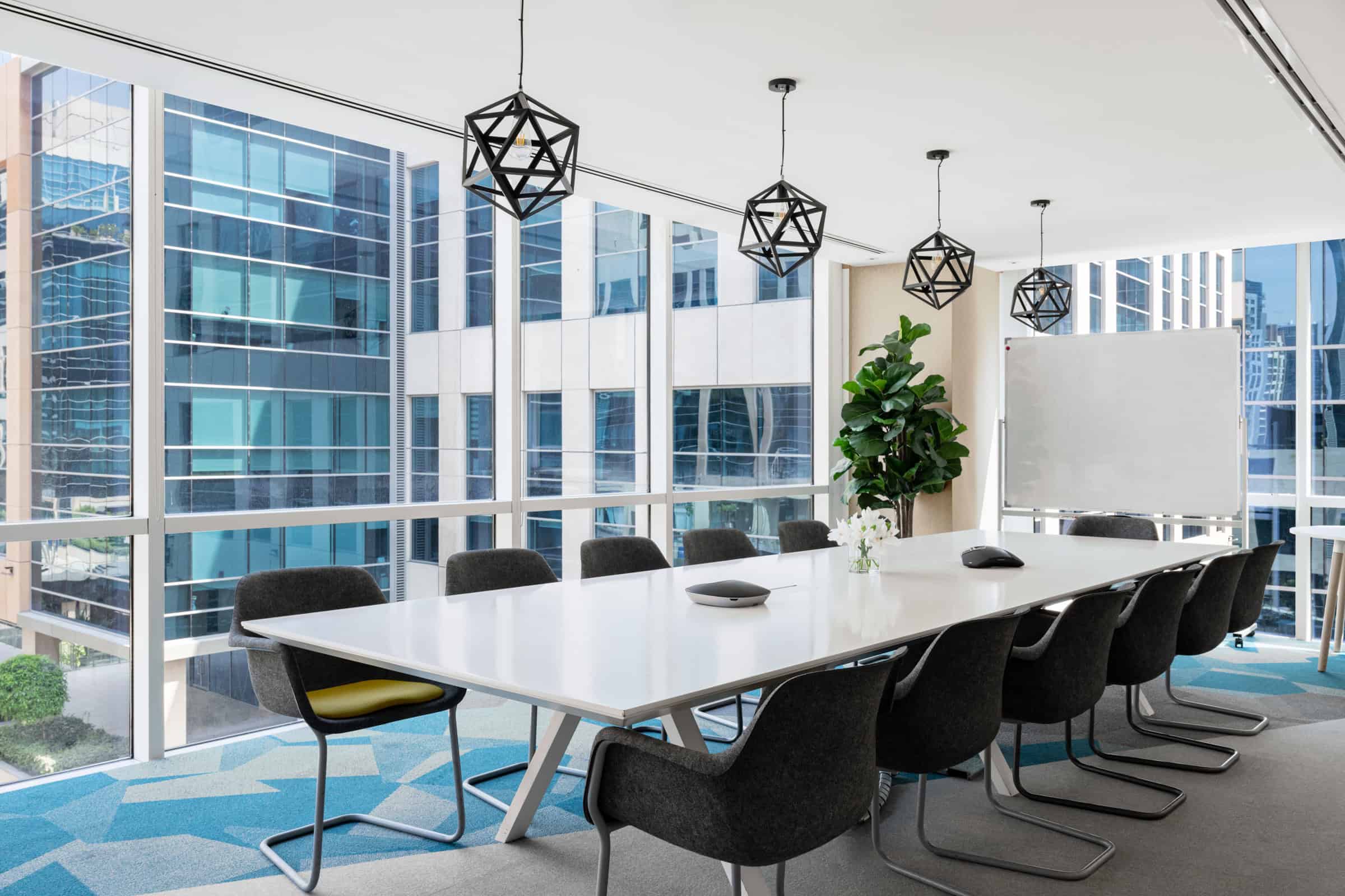 Bright, contemporary conference room with large windows overlooking Dubai's skyline, ideal for meetings and collaborations.