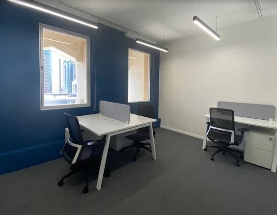 Modern coworking desks in Dubai UAE with city views.