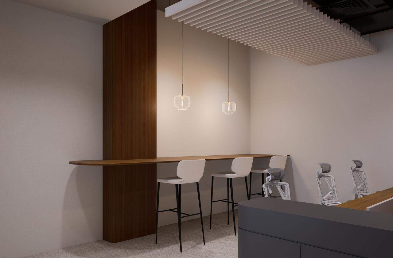 Contemporary UAE office interior with high-top seating and elegant pendant lights.