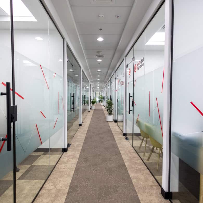 Glass office doors and corridor at Nextspace UAE coworking hub.