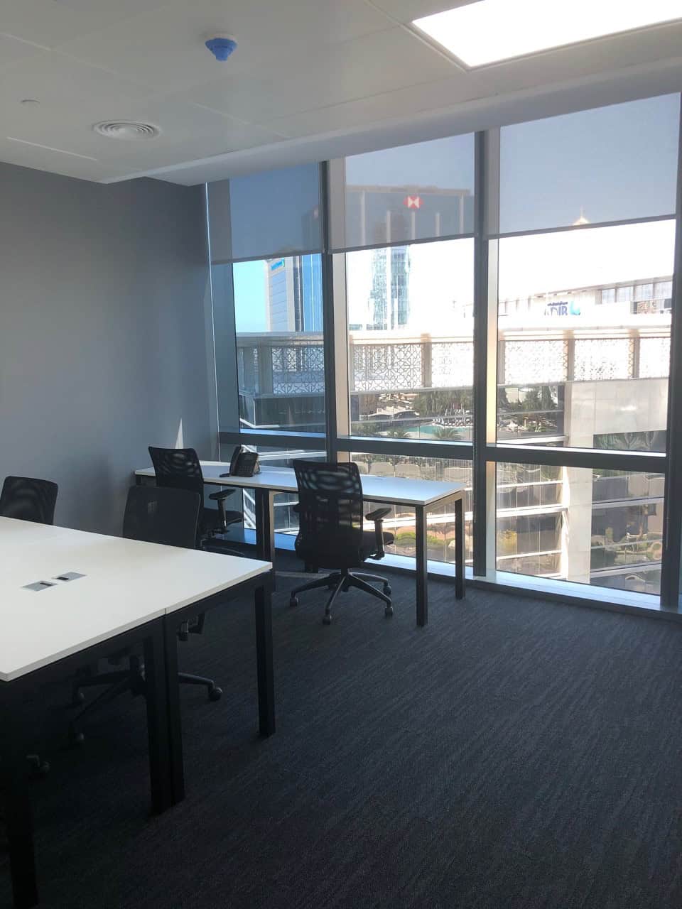 Bright office with large windows and ergonomic chairs in Dubai coworking space.