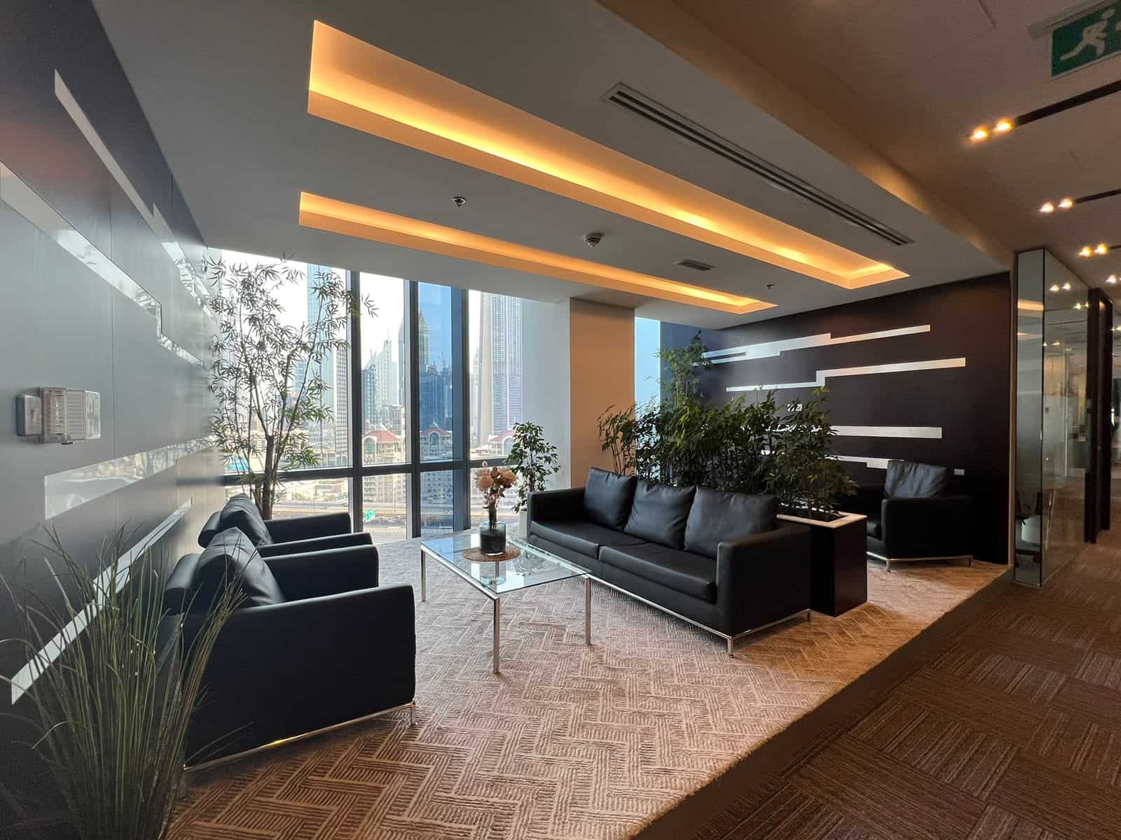 Luxurious coworking space in Dubai with modern furniture, greenery, and stunning skyline vistas.