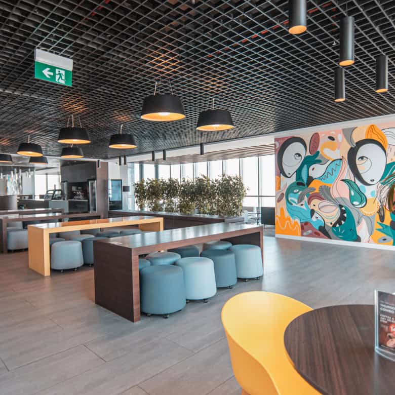 Bright, stylish workspace inside Nextspace UAE featuring contemporary furniture and colorful wall art.