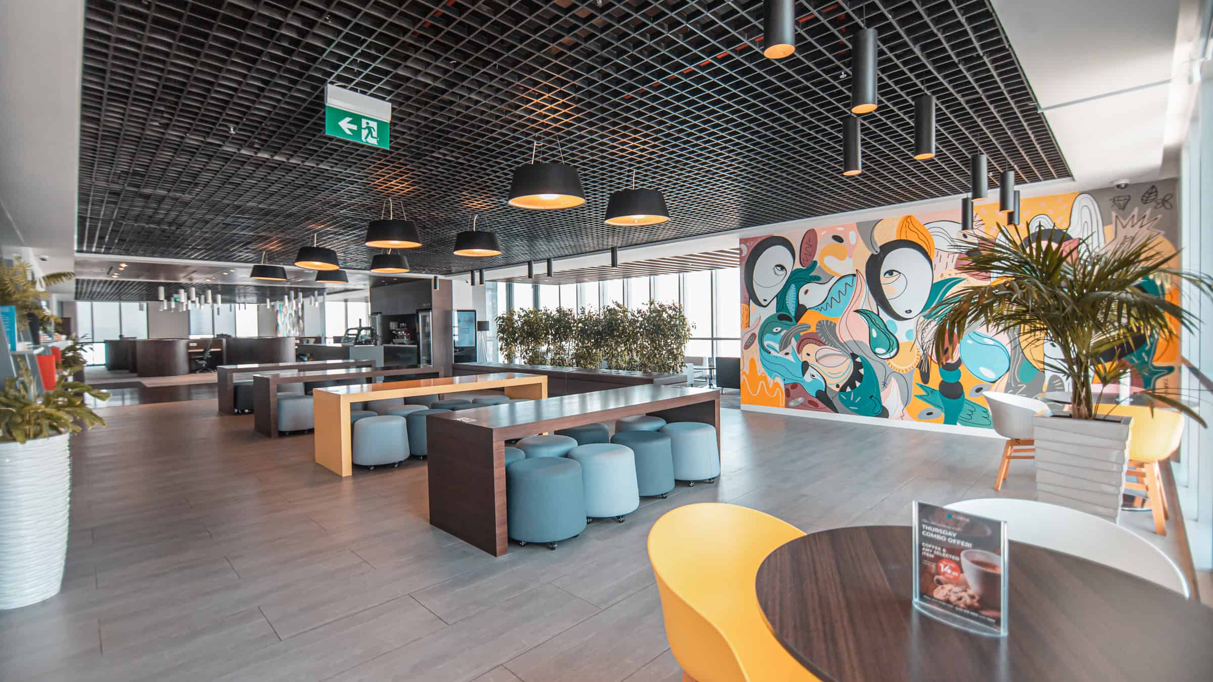 Bright, stylish workspace inside Nextspace UAE featuring contemporary furniture and colorful wall art.