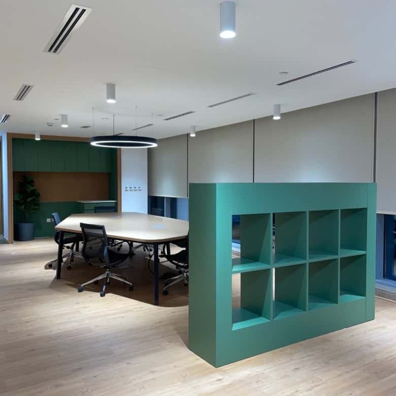 Indoor workspace with meeting table, chairs, and stylish shelving in Dubai UAE.