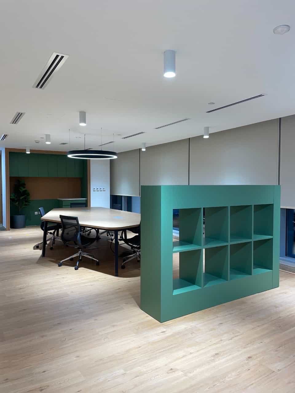Indoor workspace with meeting table, chairs, and stylish shelving in Dubai UAE.
