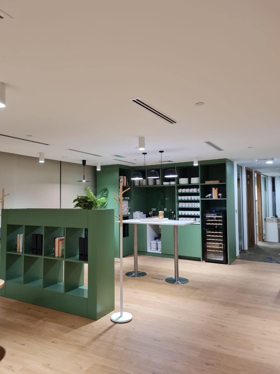 Spacious coworking environment at Nextspace UAE with modern decor and vibrant green accents.