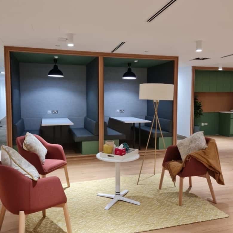 Modern coworking space with private booths and lounge chairs in Dubai UAE.