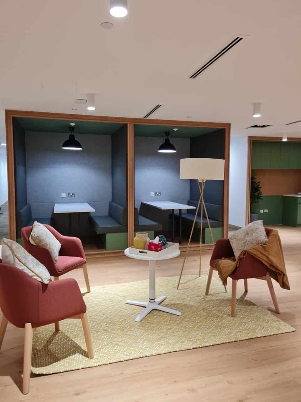 Modern coworking space with private booths and lounge chairs in Dubai UAE.