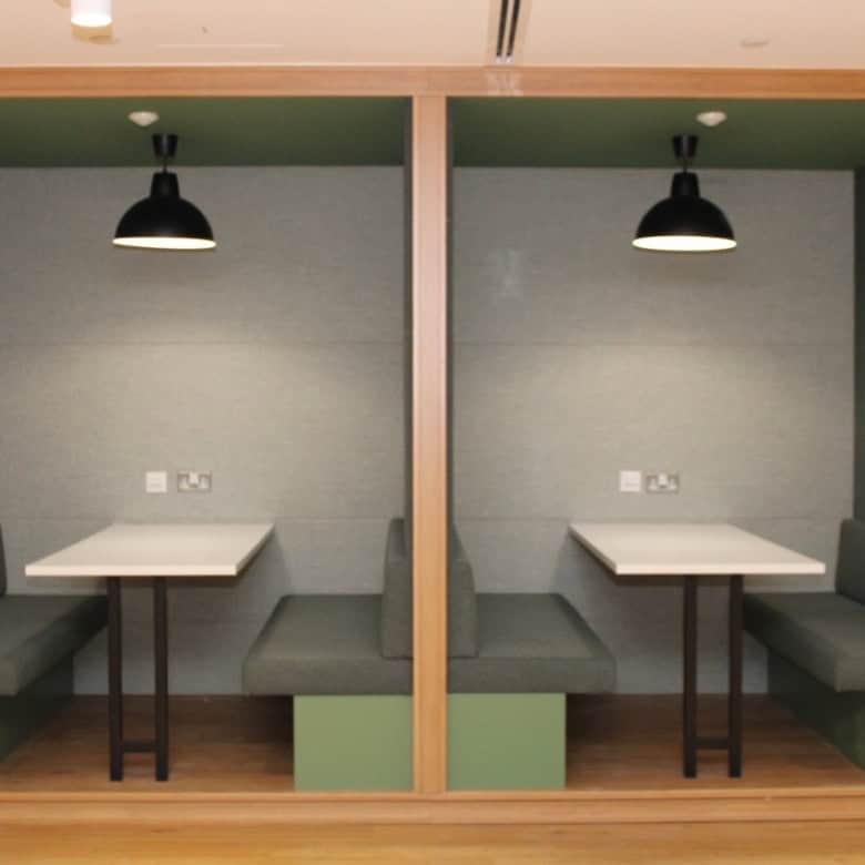 Modern coworking booths in UAE with private seating, ideal for meetings and remote work at Nextspace. Perfect workspace solution.