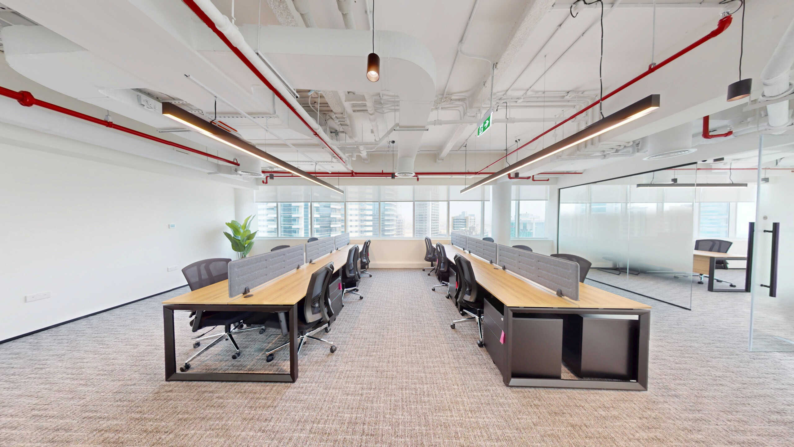 Bright, flexible office environment in Dubai with workstations and meeting areas.