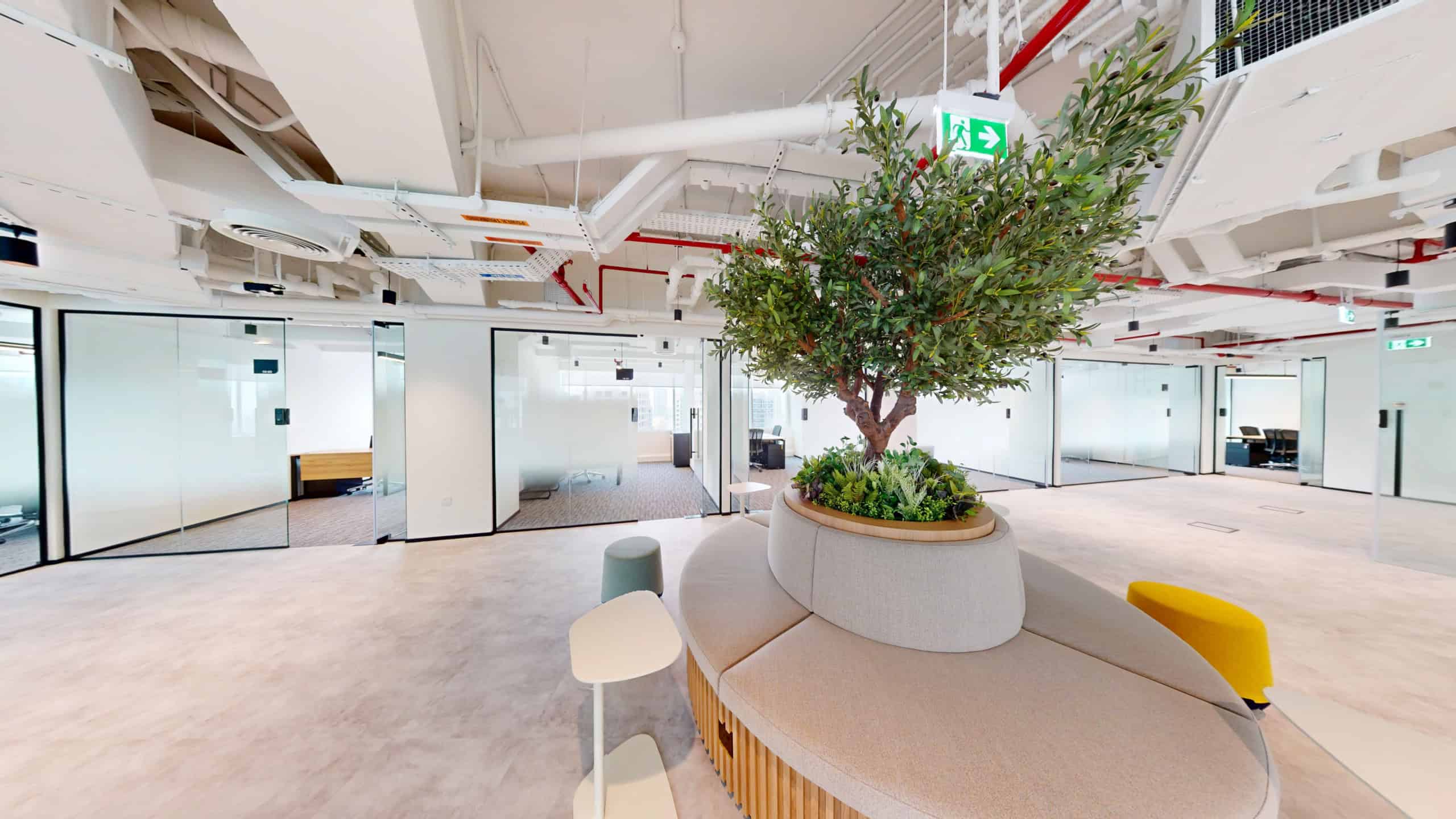 Bright, stylish coworking office interior with modern furniture, spacious layout, and greenery in Dubai UAE.