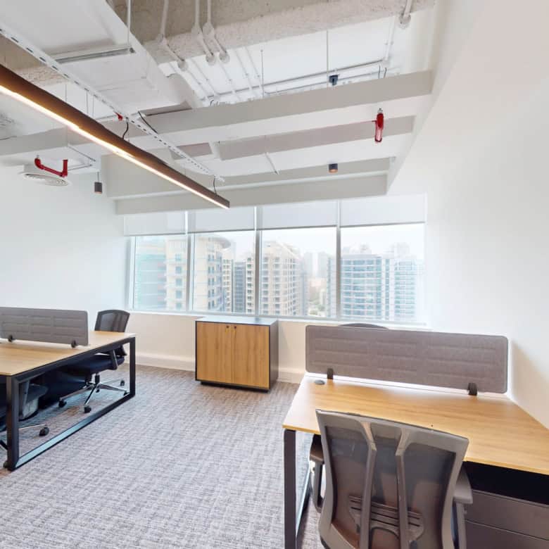 Bright coworking office in Dubai with large windows and contemporary furniture.