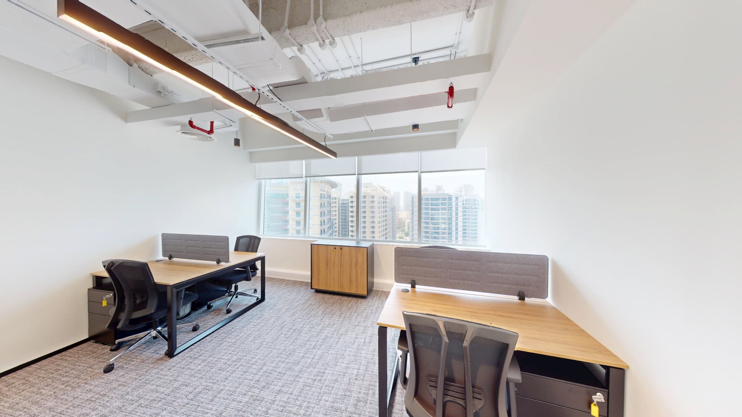 Bright coworking office in Dubai with large windows and contemporary furniture.