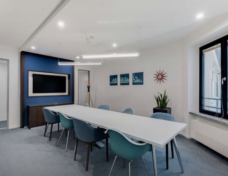 Bright, contemporary meeting room at Nextspace UAE with large windows and stylish decor.