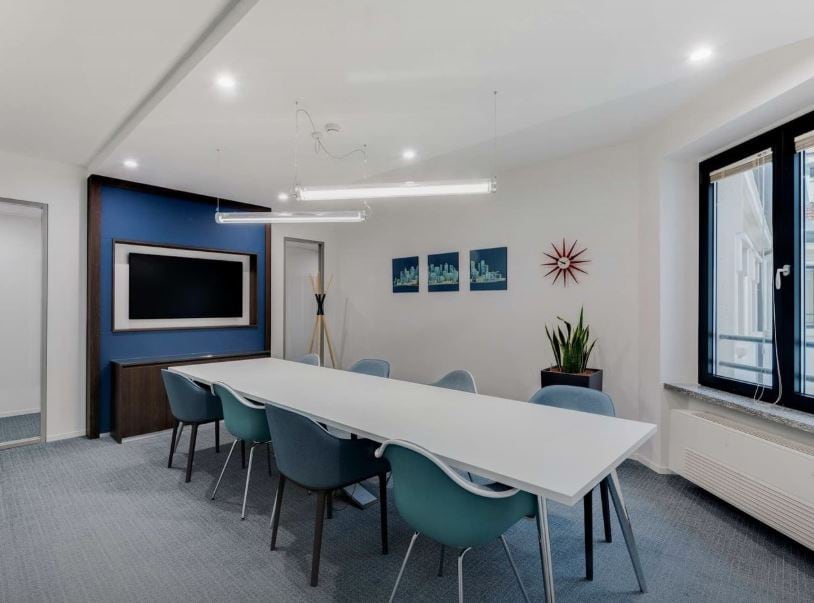 Bright, contemporary meeting room at Nextspace UAE with large windows and stylish decor.