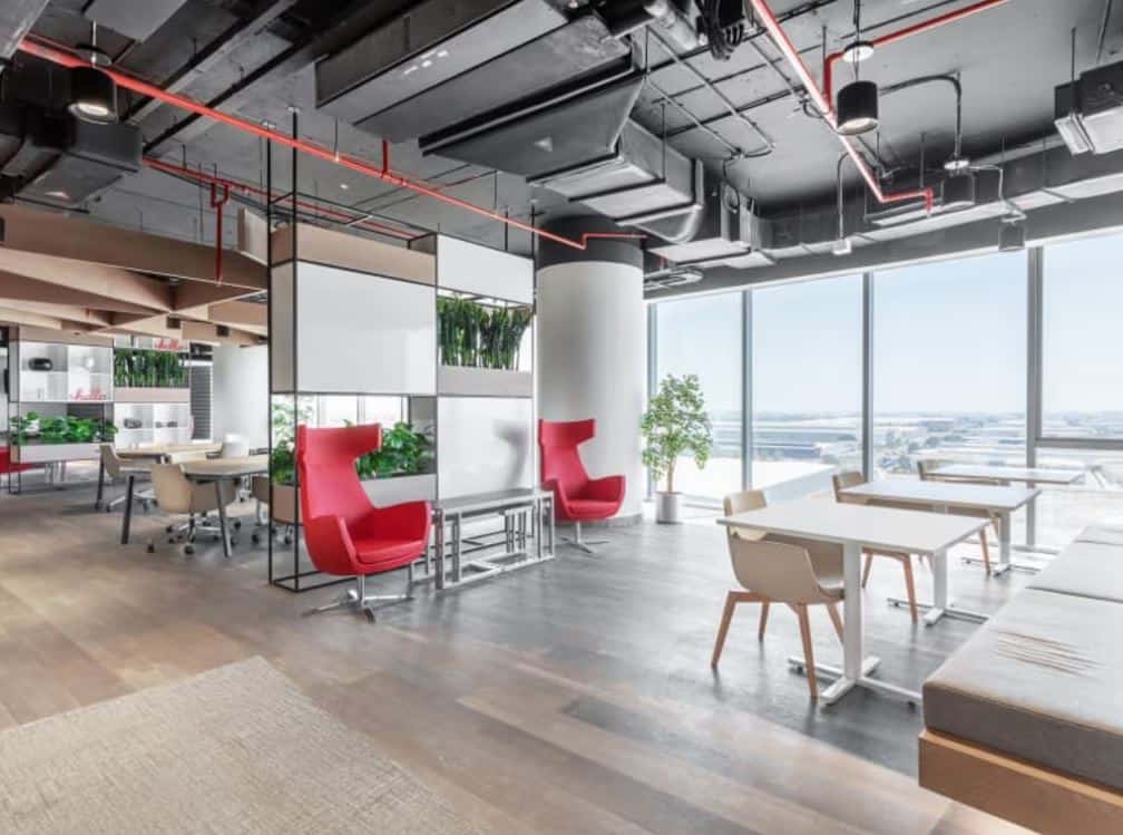 Bright, stylish coworking environment with large windows in Nextspace UAE.