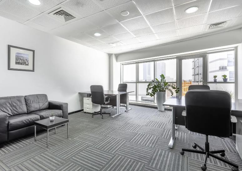 Modern coworking space in UAE with comfortable seating and large windows.