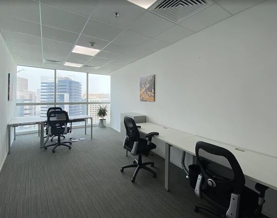 Modern UAE coworking space with desks and chairs.