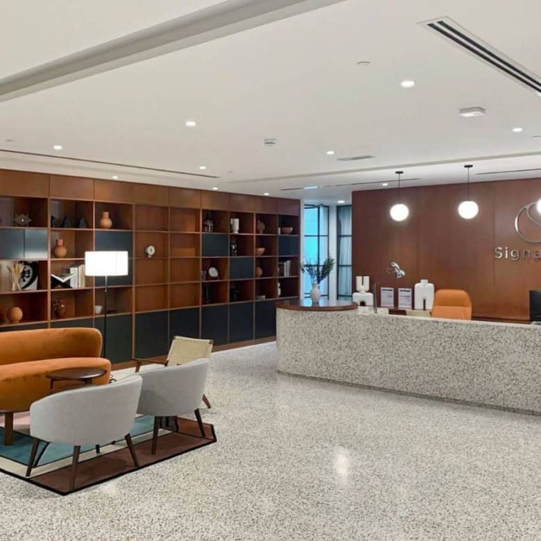 Bright, stylish reception area with seating and decorative shelving in Dubai UAE.