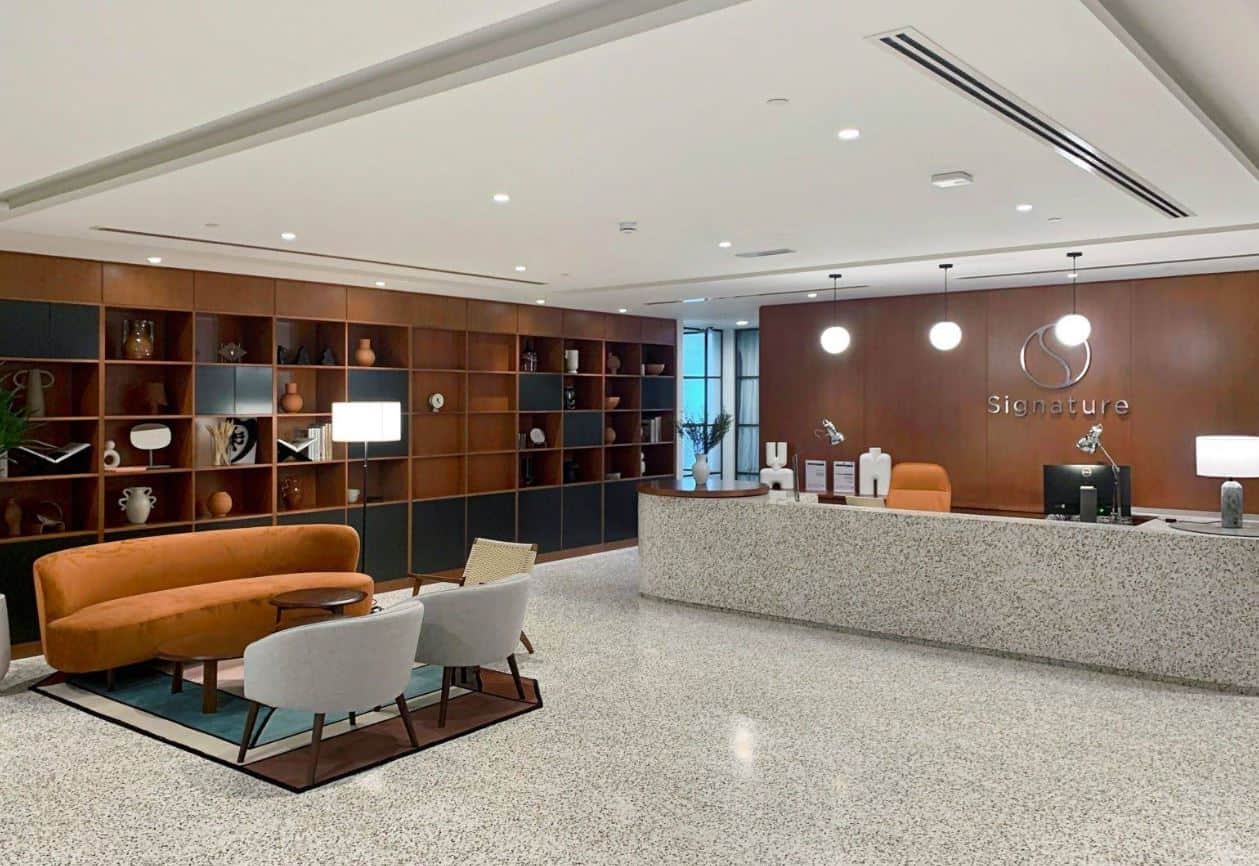 Bright, stylish reception area with seating and decorative shelving in Dubai UAE.