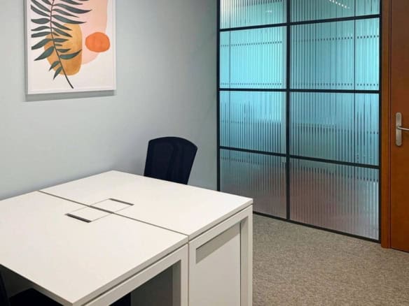 Bright coworking workspace in Dubai featuring glass walls and contemporary design for productivity.