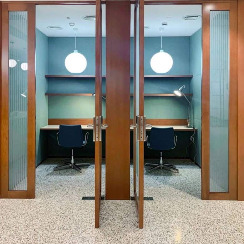 Quiet private work pods with desks, chairs, and lighting, ideal for focused work in Dubai's Nextspace UAE coworking space.