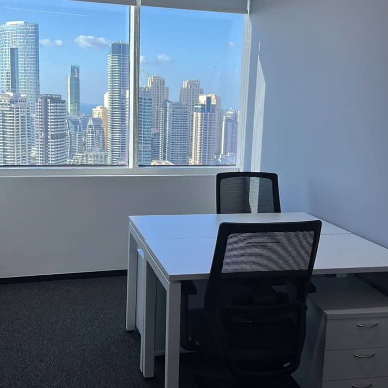 Bright office with cityscape view ideal for startups and freelancers.