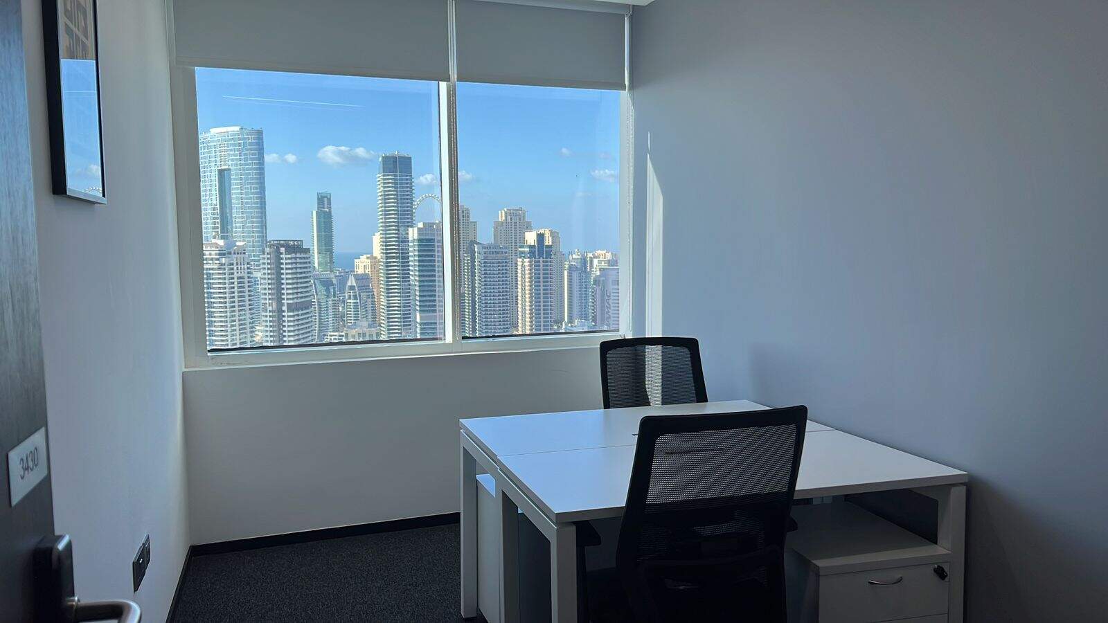 Bright office with panoramic city views of Dubai skyscrapers, modern workspace, coworking space, professional environment, Nextspace UAE.