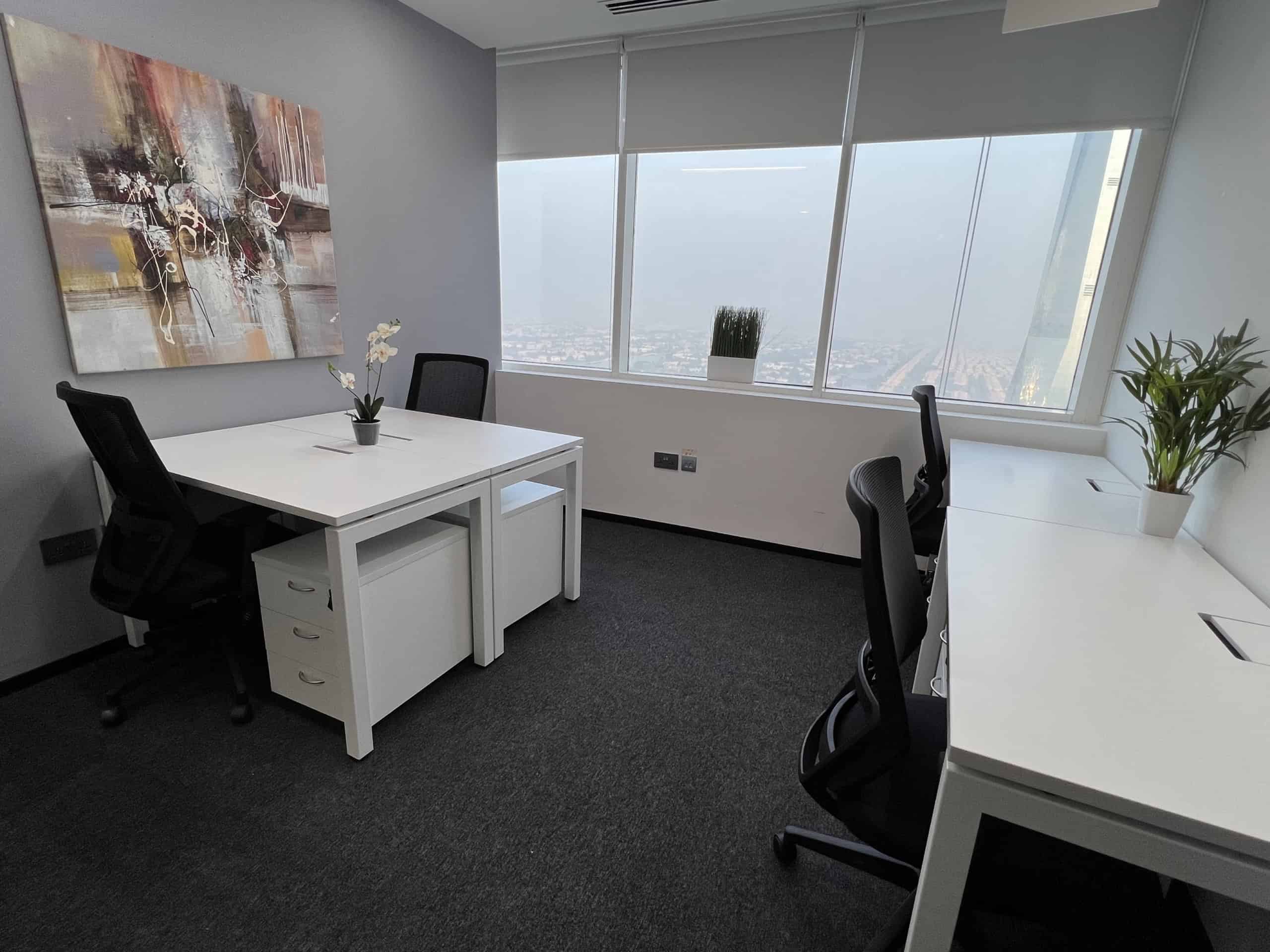 Bright, stylish office with large windows, contemporary furniture, and greenery for productivity.