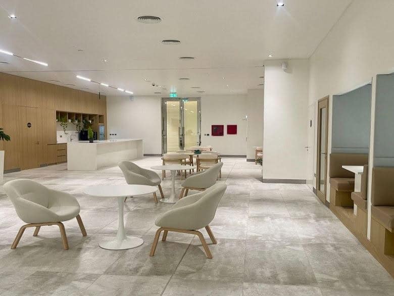 Bright, stylish office with comfortable seating and private booths for collaboration.