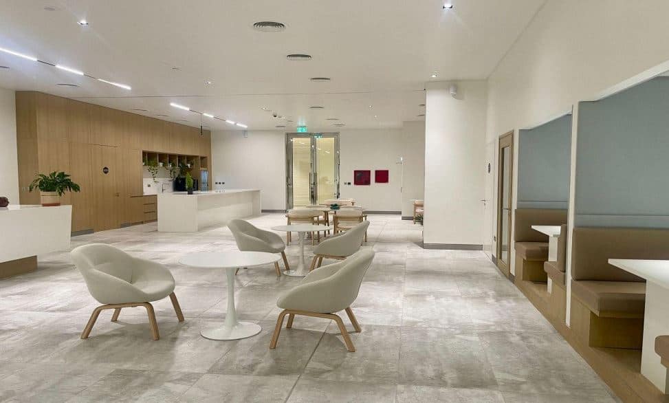 Bright, stylish office with comfortable seating and private booths for collaboration.