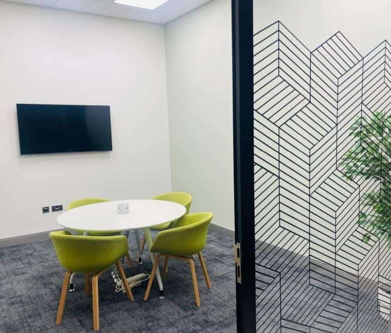 Modern coworking space in Dubai, UAE with meeting rooms, private offices, and vibrant work environment.