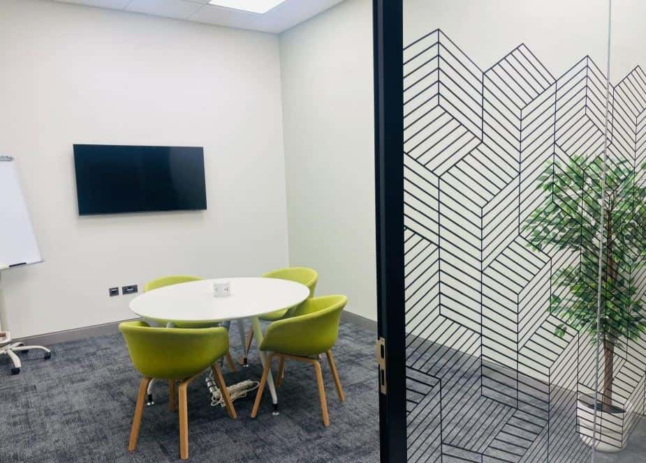 Modern coworking space in Dubai, UAE with meeting rooms, private offices, and vibrant work environment.