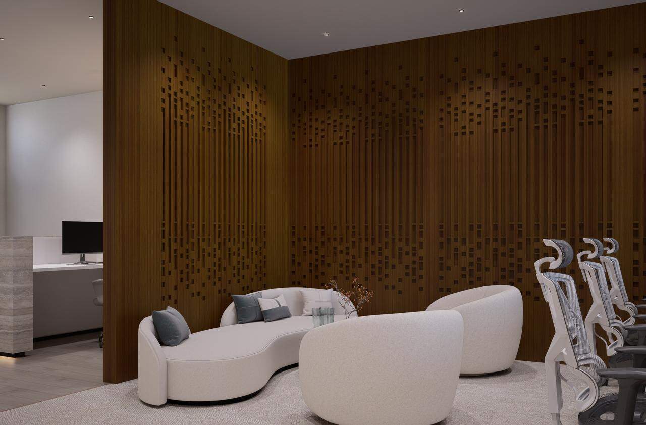 ALT text: Elegant UAE coworking lounge with modern seating and contemporary wooden wall design.