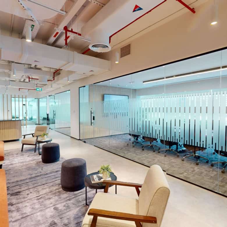 Contemporary Dubai coworking space with lounge area, private offices, and collaborative zones.