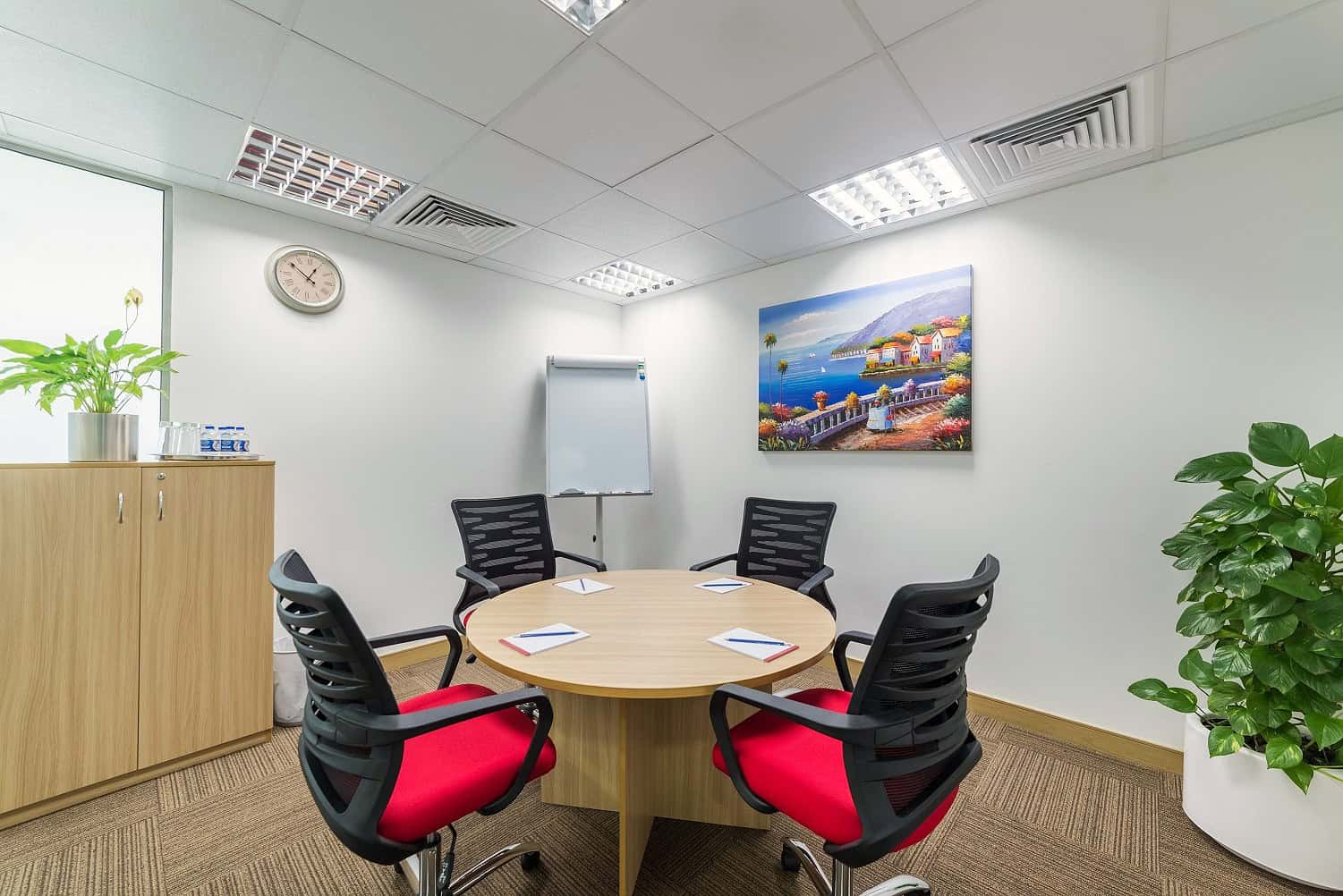 Bright, professional coworking office in Nextspace UAE with meeting area, comfortable chairs, and contemporary decor.