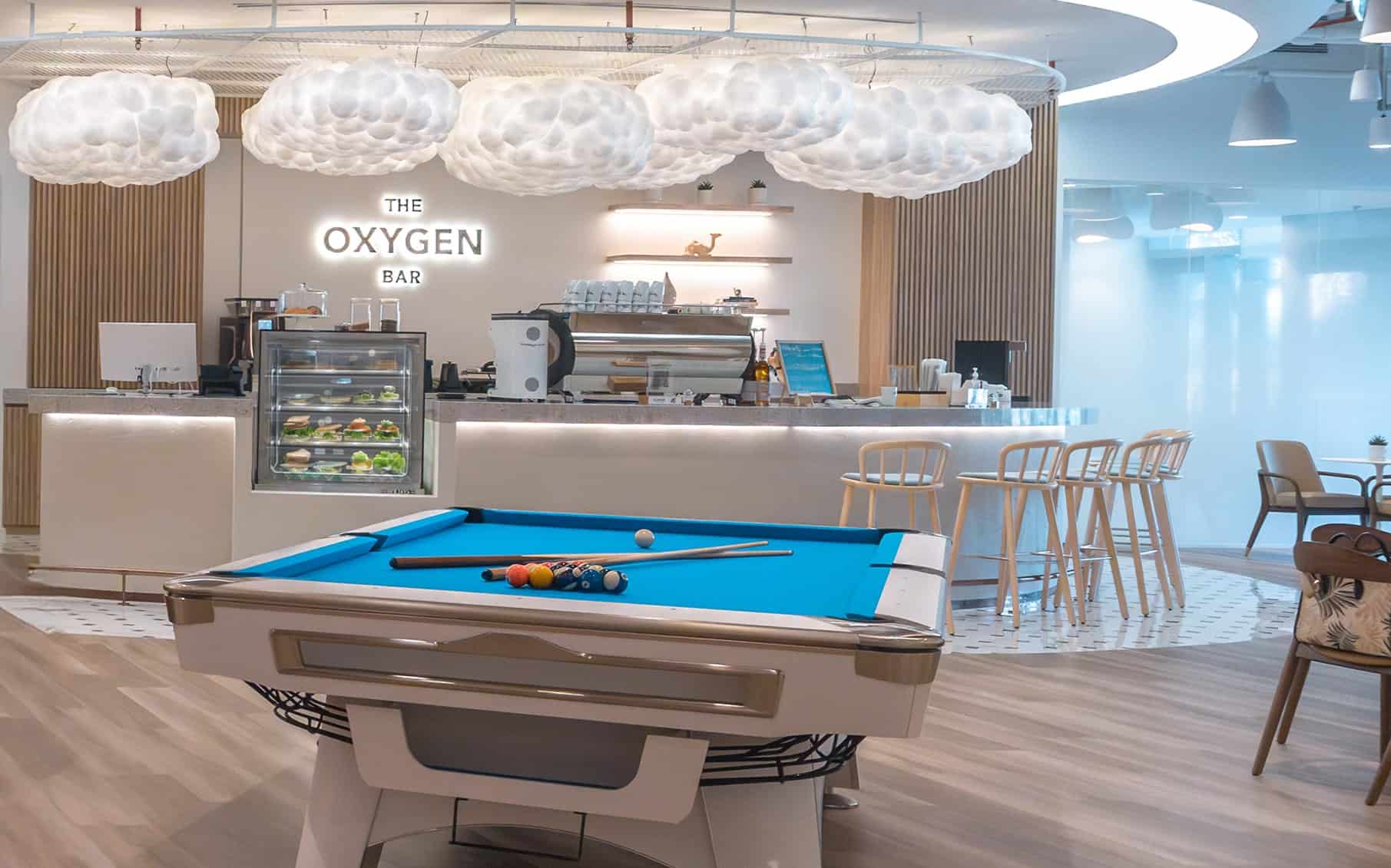 Bright coworking lounge featuring pool table, bar, and relaxed seating at Nextspace UAE.