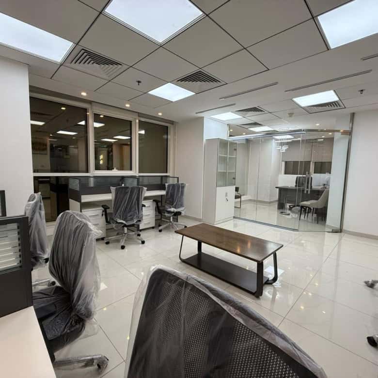 Bright and sleek office interior with ergonomic chairs and glass-walled conference rooms.