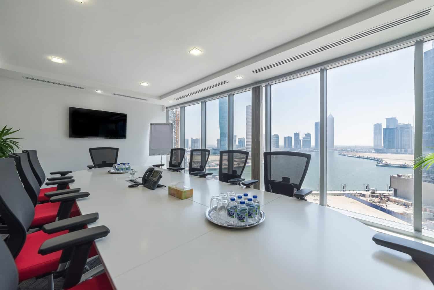 Modern Dubai office with city skyline view, executive meeting room, and conference facilities.