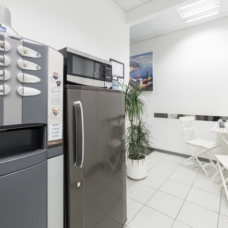 Spacious office lounge at Nextspace UAE featuring white seating and a relaxing environment.