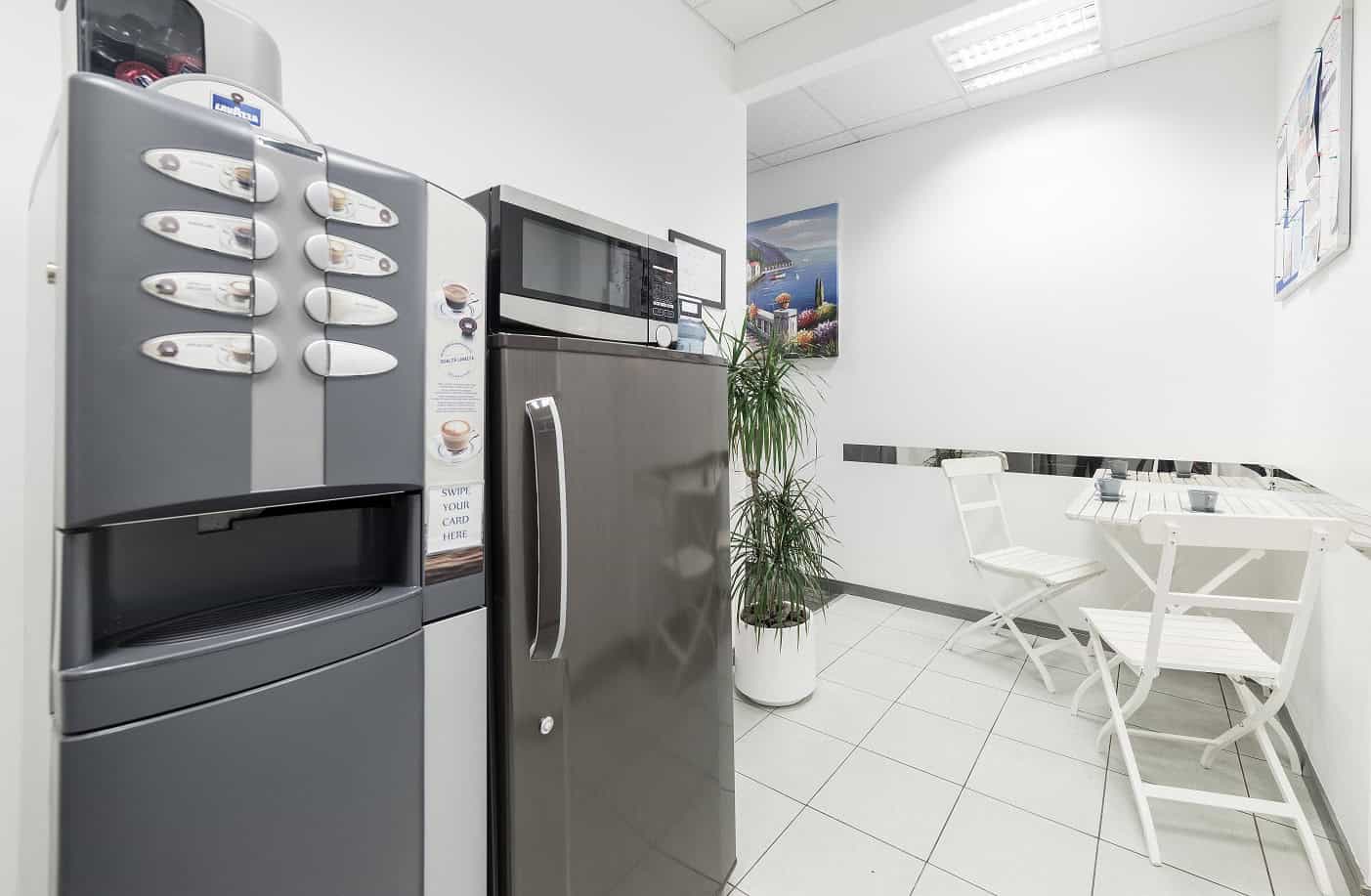 Spacious office lounge at Nextspace UAE featuring white seating and a relaxing environment.